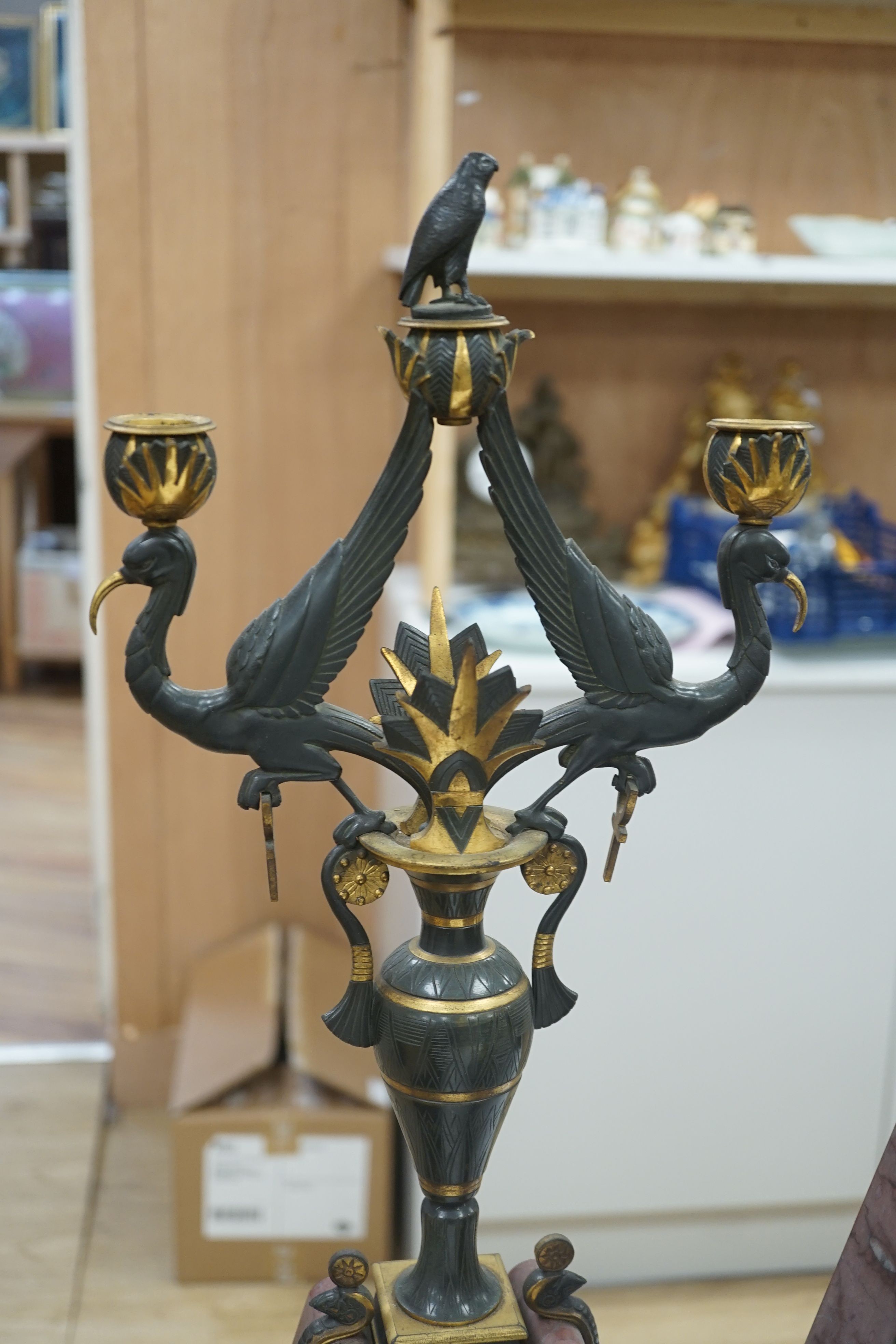A late 19th century French Egyptian Revival gilt bronze and rouge marble clock garniture, 51cm